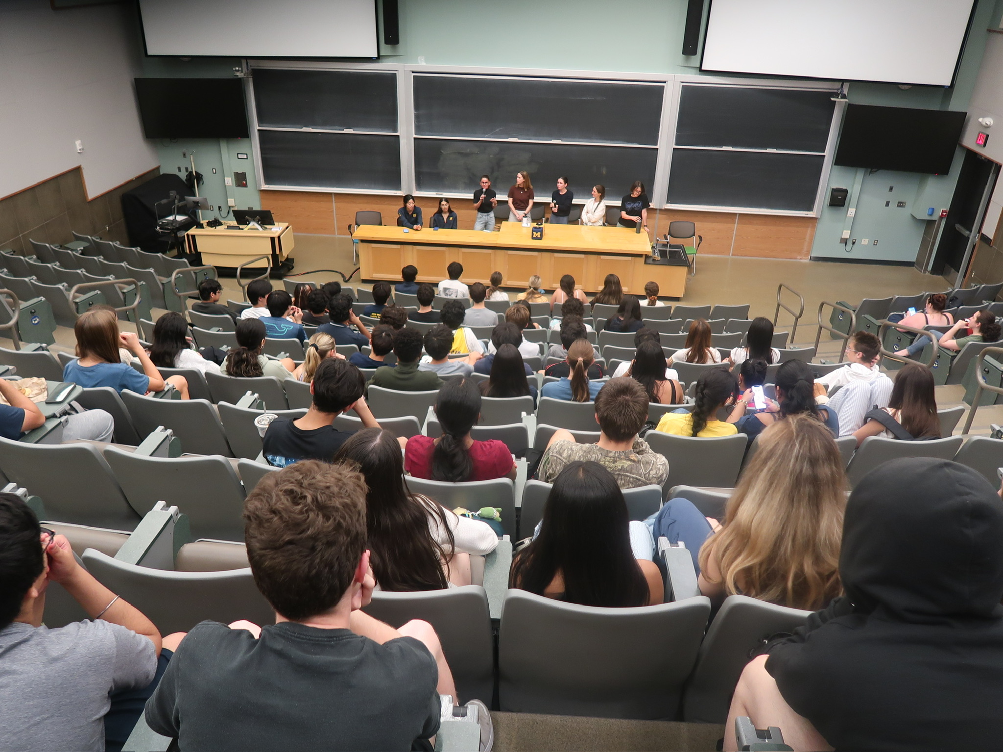 Large group gathered in a debate lecture hall